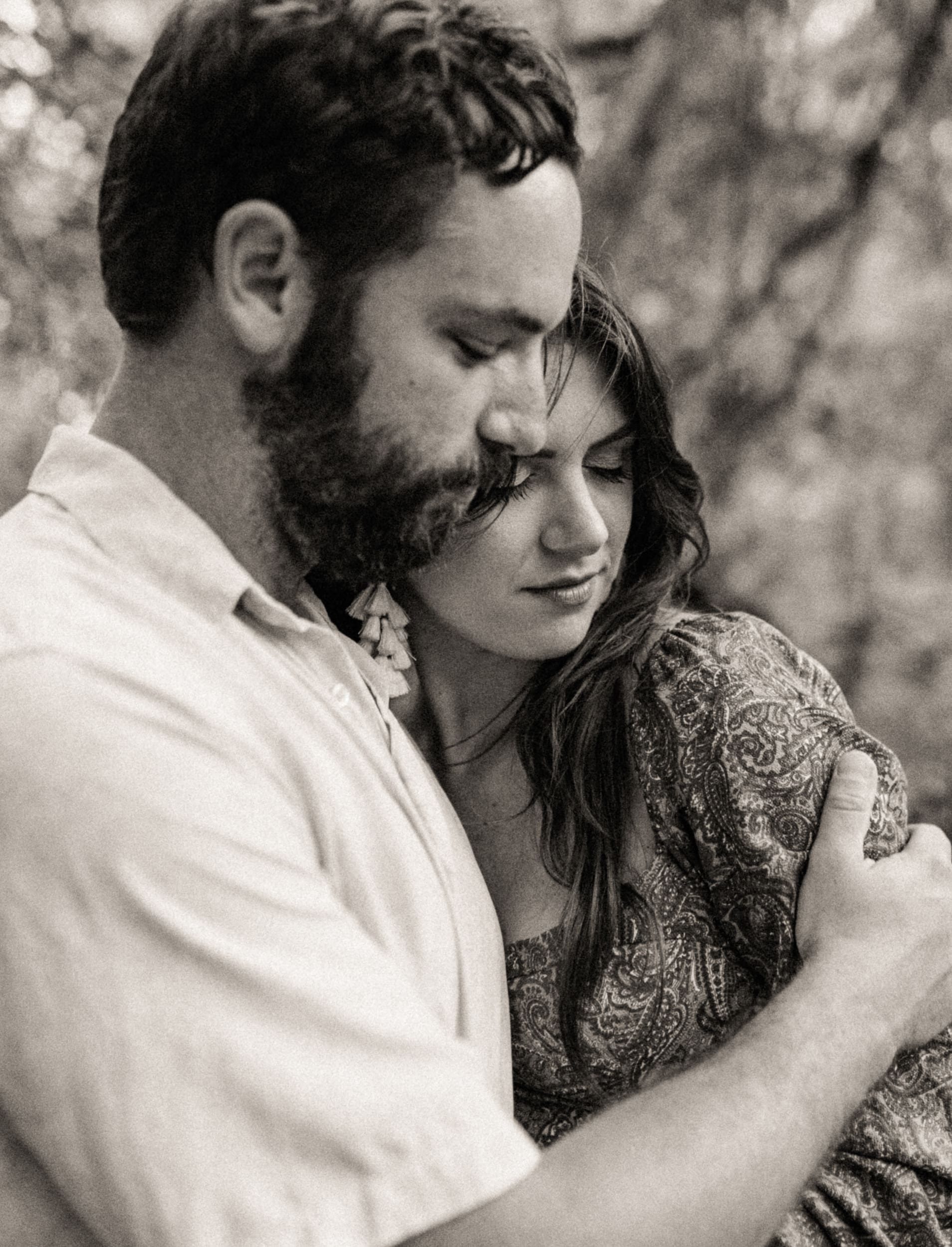 Close-up black and white portrait of a couple embracing during an engagement session in Jacksonville, Florida.