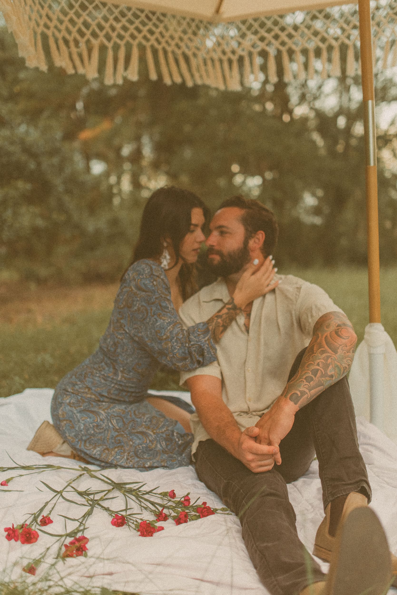 Intimate editorial-style portrait of a couple sitting together during a backyard engagement session in Jacksonville, Florida.