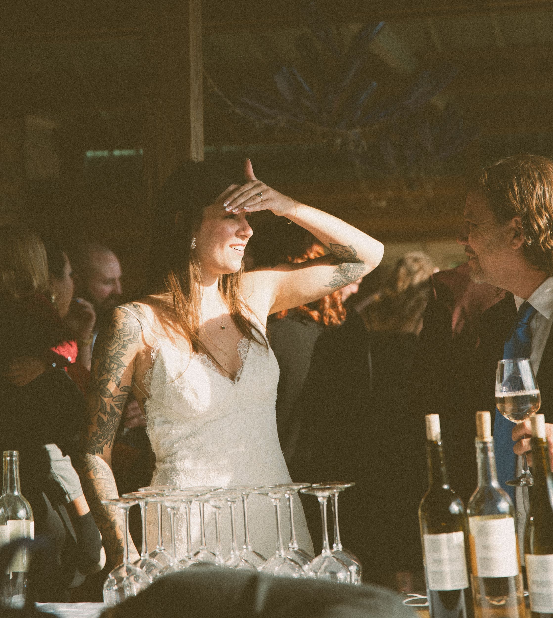 Candid photo of bride laughing during wedding reception at Parker-Binns Vineyard North Carolina, documentary wedding photography by Brandi Denslow.