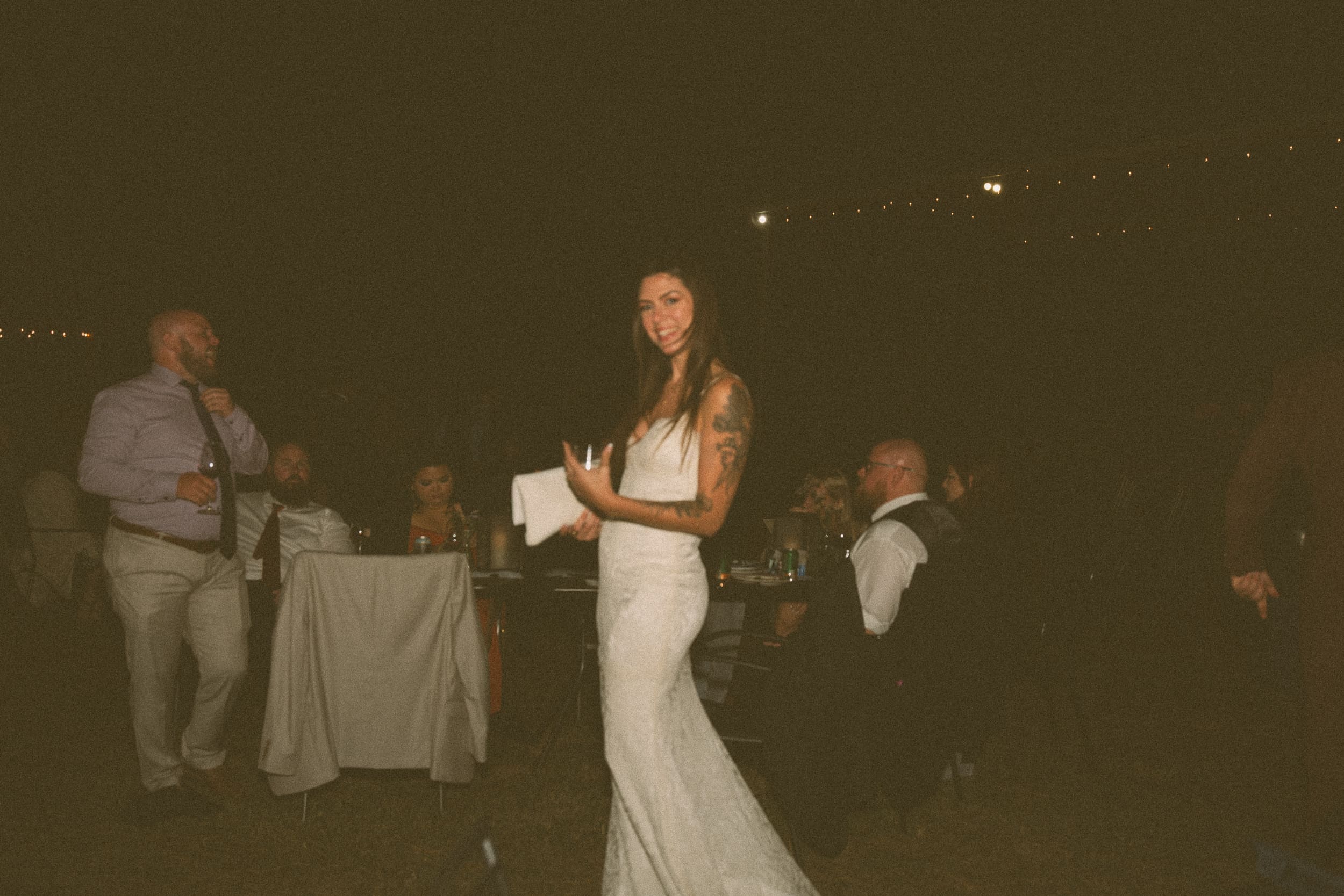 Bride during an evening wedding reception at vineyard in North Carolina, captured candidly on film. 