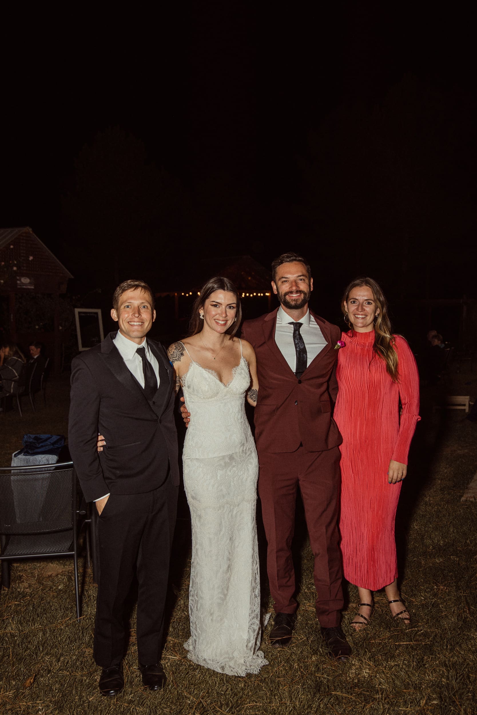Bride, groom and guests smiling at together at end of evening reception at Parker-Binns Vineyard North Carolina, candid wedding photography. 