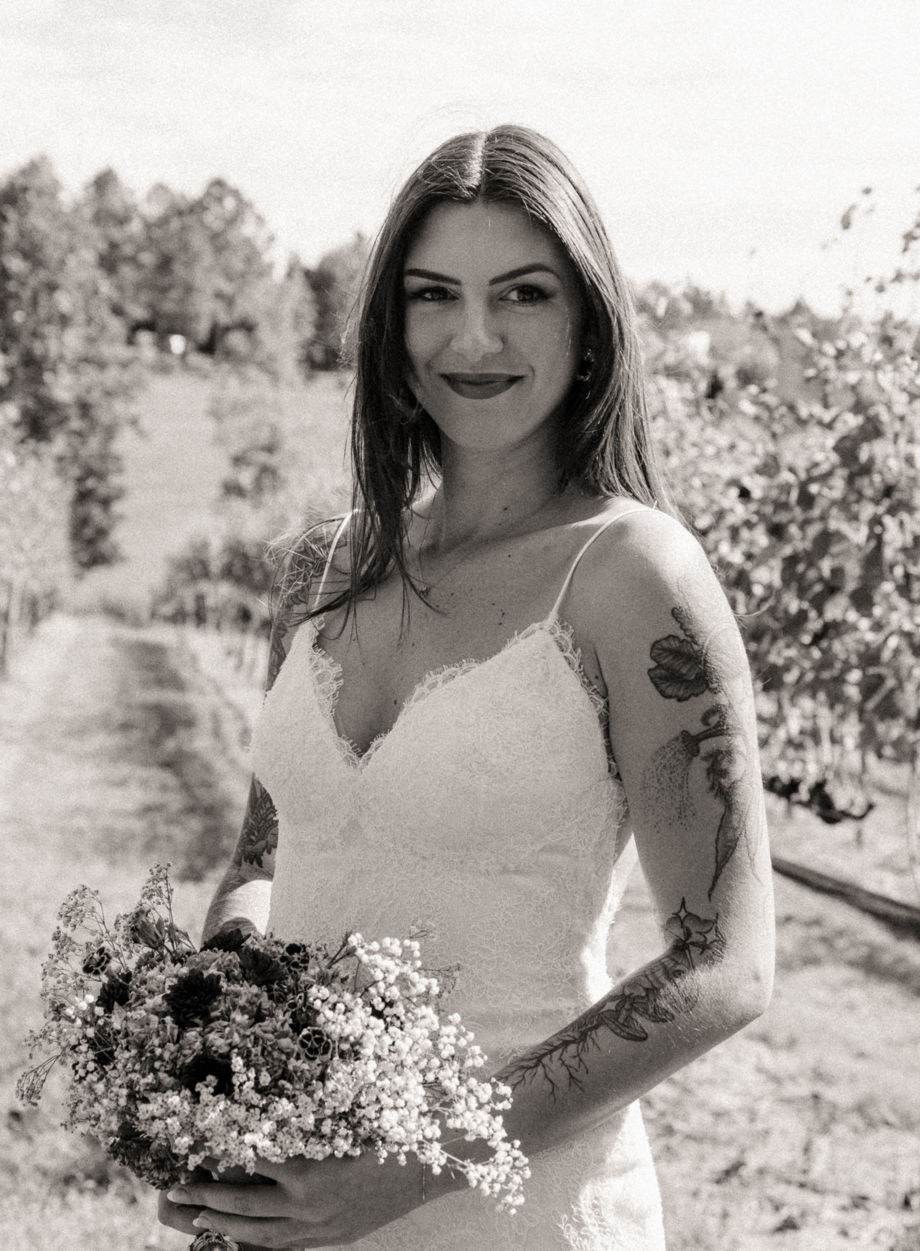 Black and white bridal portrait at Parker-Binns Vineyard North Carolina with wildflower bouquet.