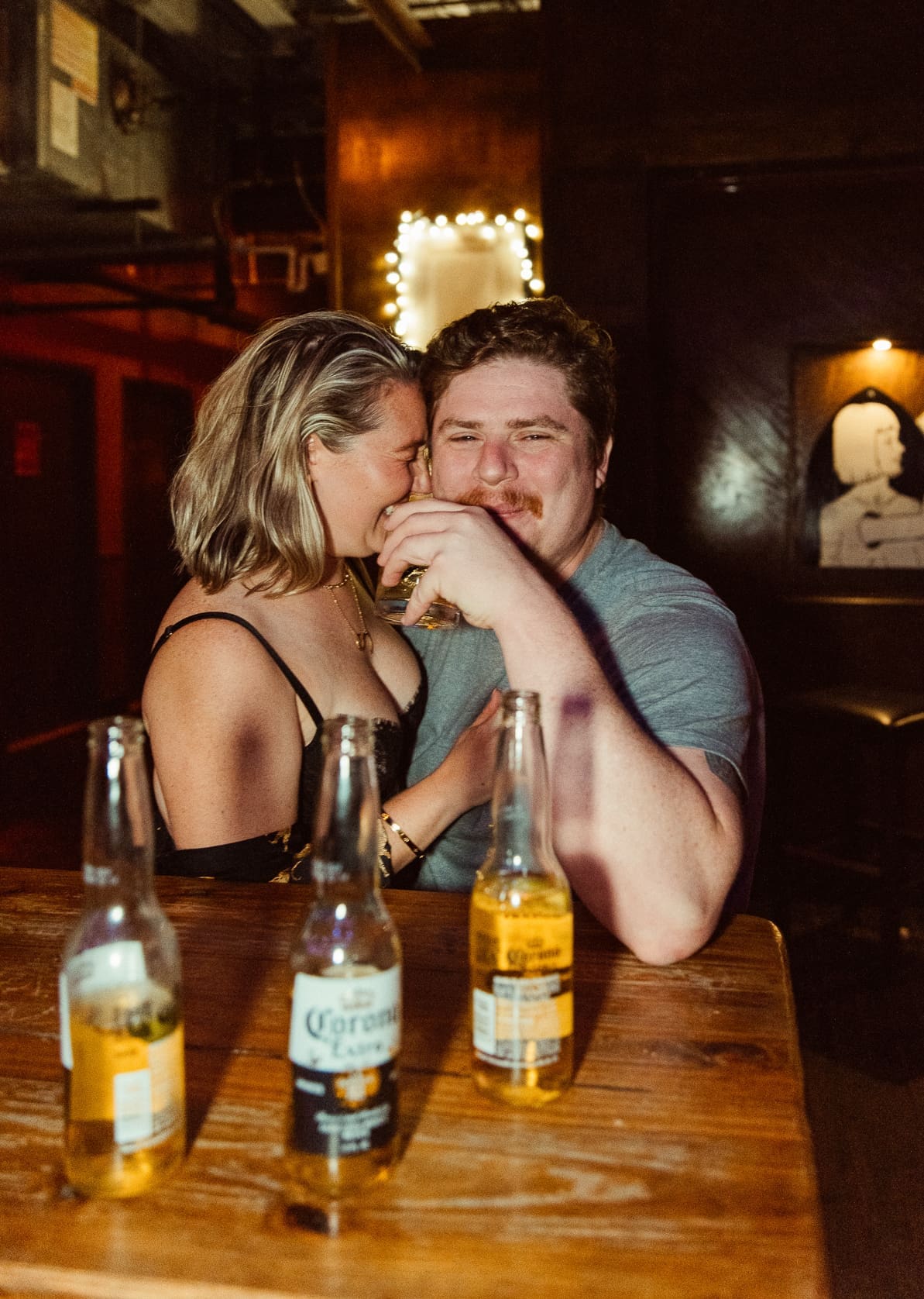 Candid intimate moment between engaged couple at a bar during St. Augustine engagement session, Brandi Denslow Photography. 