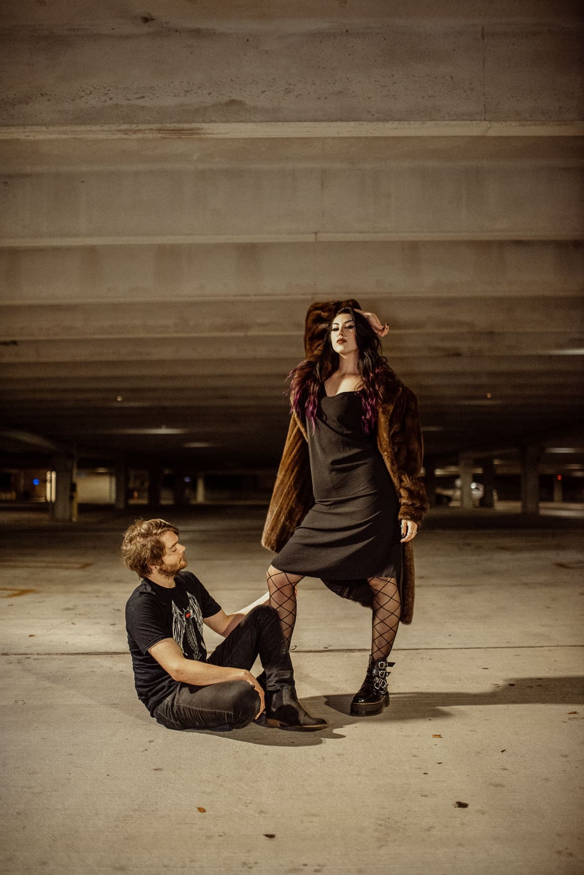Editorial engagement photo of a couple on a parking garage rooftop at night, photographed by a St. Augustine engagement photographer. 