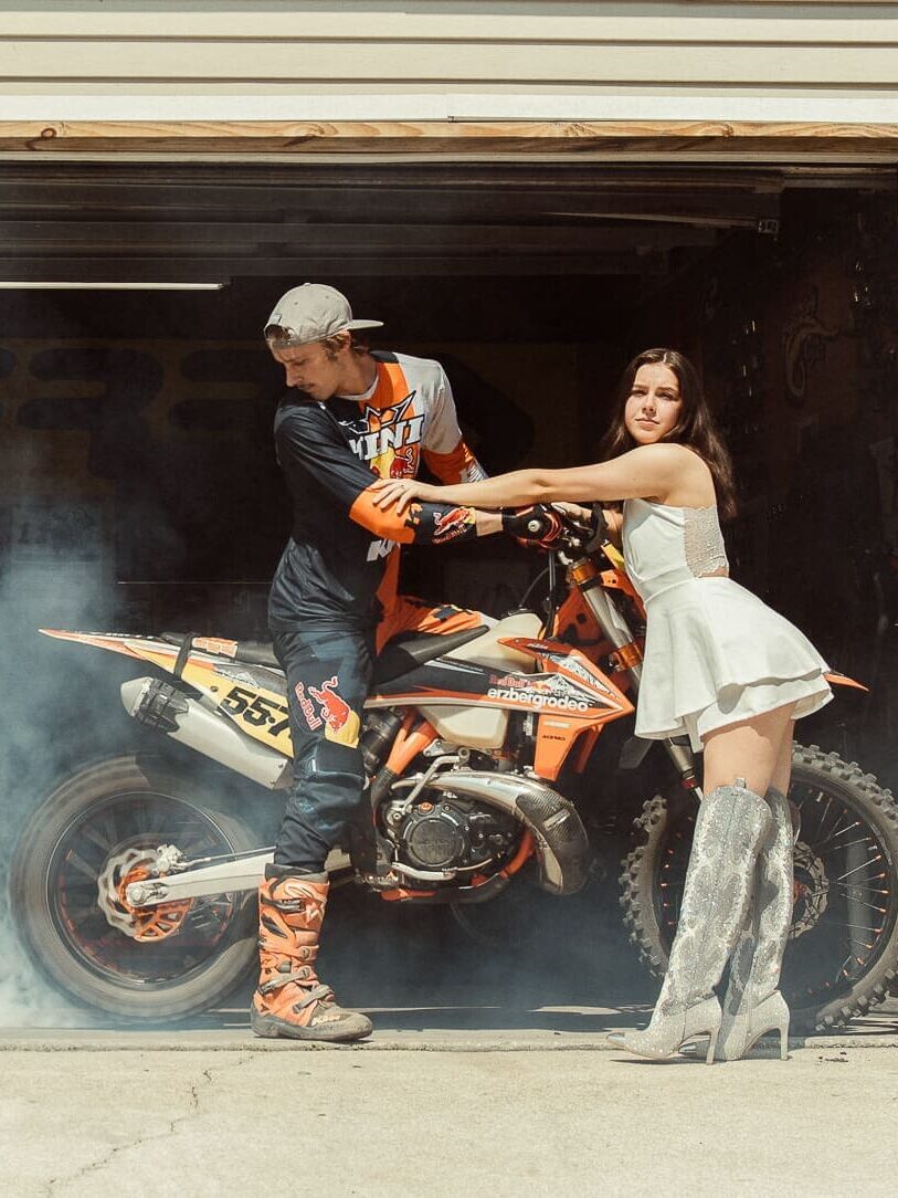 Creatively directed engagement session featuring a couple with a dirt bike during a unique Florida engagement shoot. 