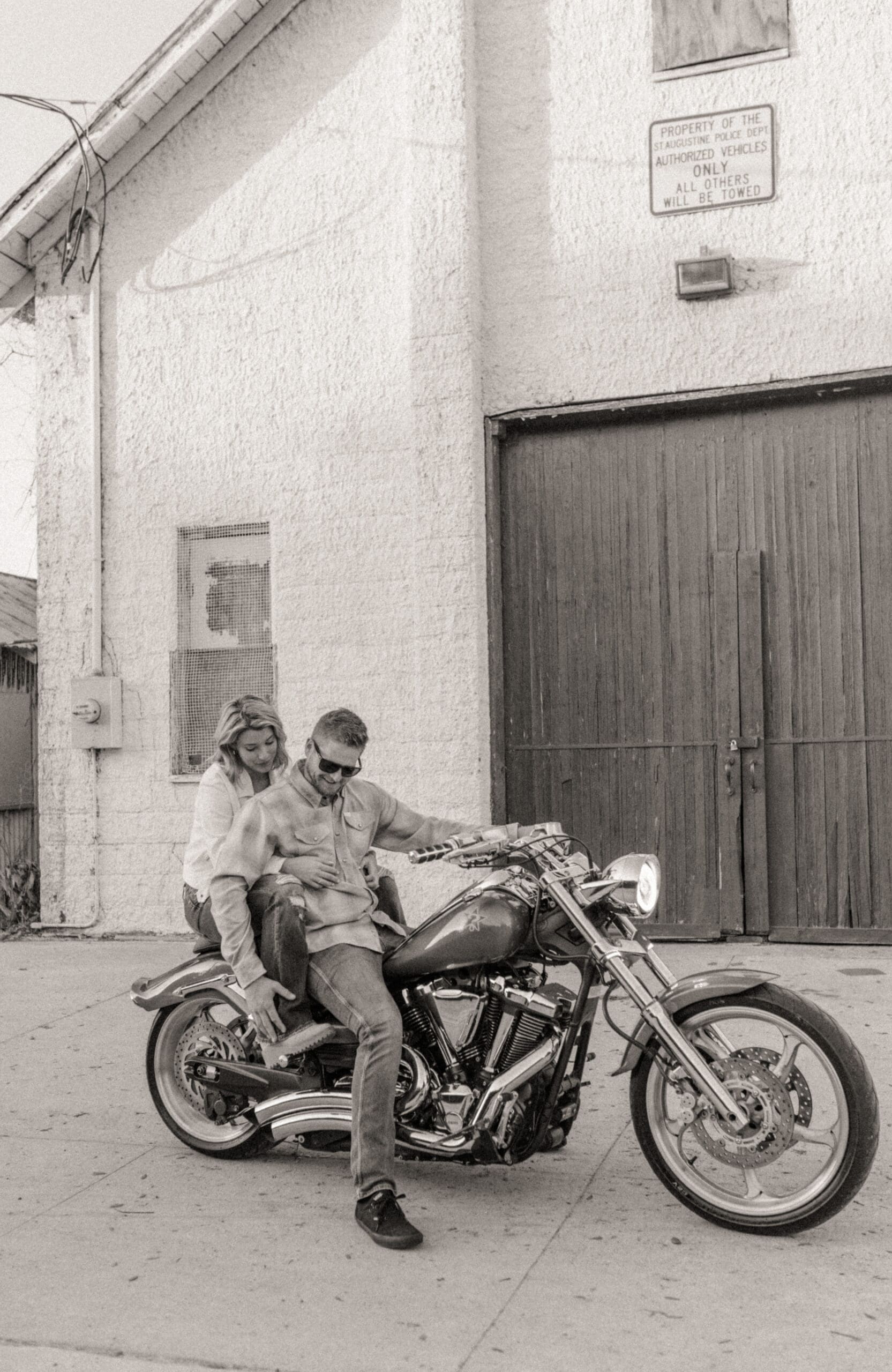 Editorial black and white engagement session with couple on vintage motorcycle in downtown St. Augustine.