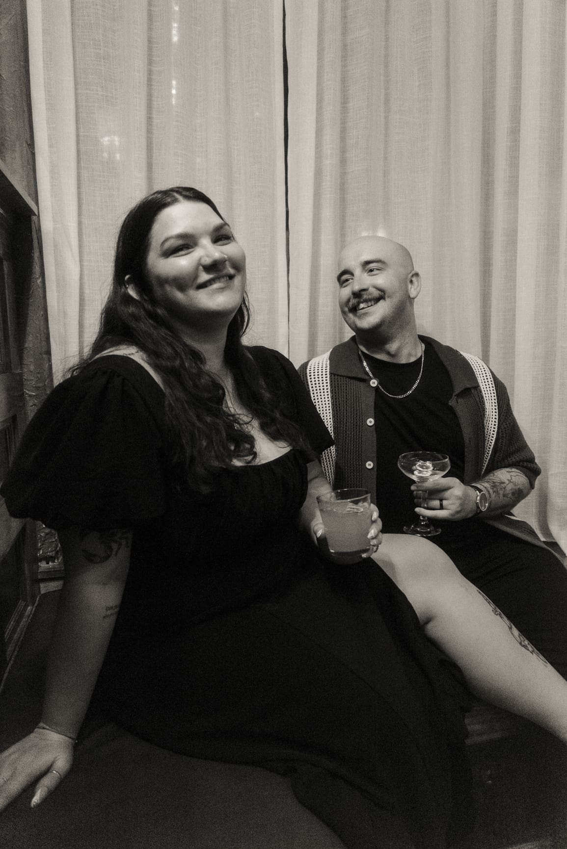 Couple laughing naturally together during a relaxed engagement session photographed by a St. Augustine wedding photographer.