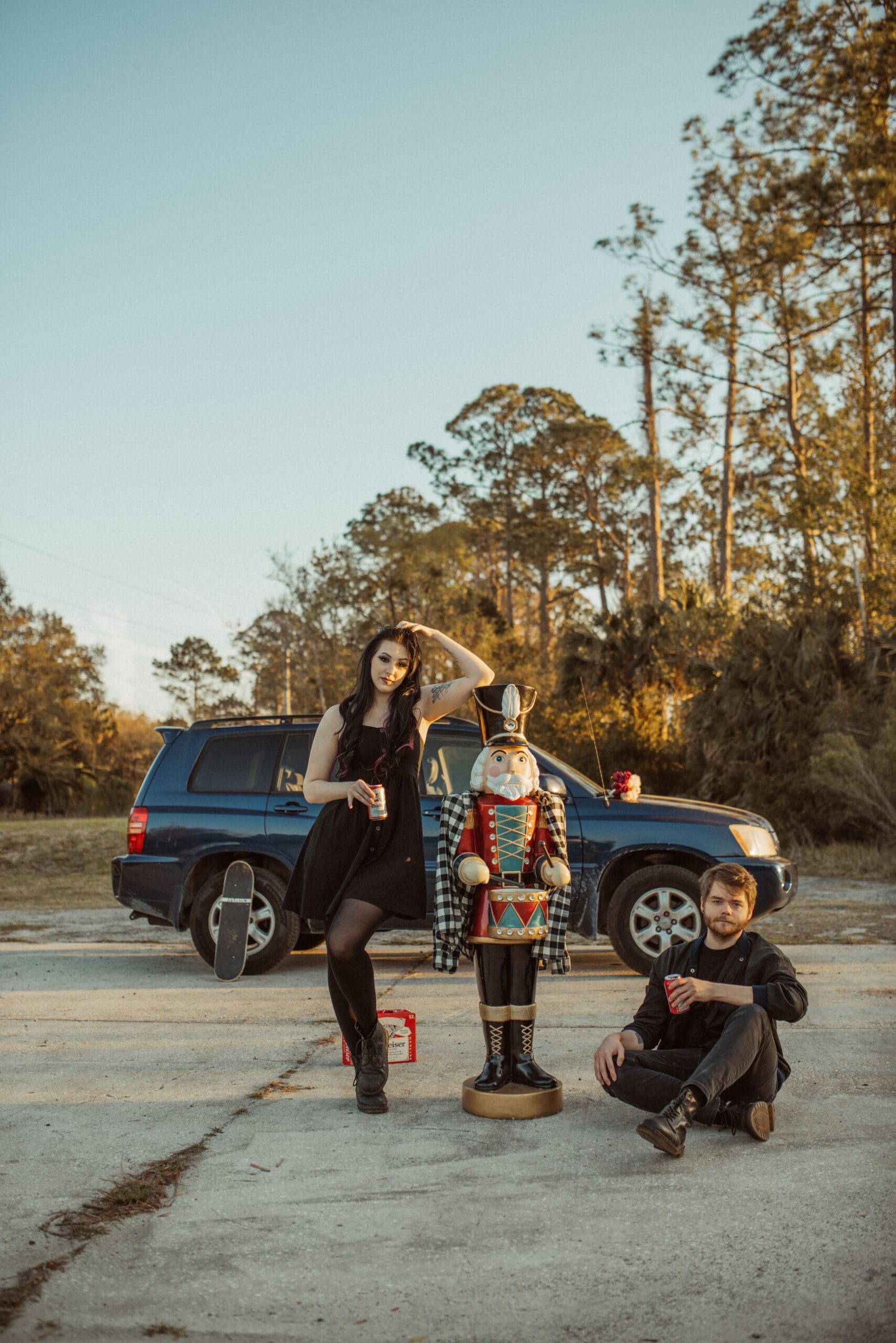 Creative editorial engagement session with couple and giant nutcracker at golden hour in St. Augustine, Florida.