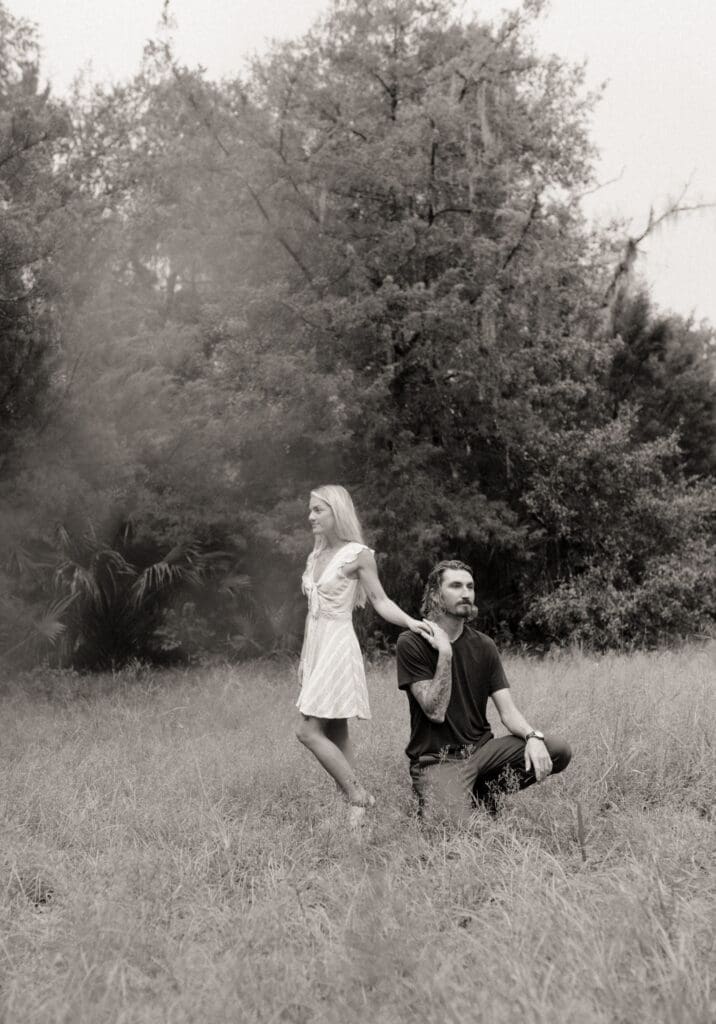 Fine art inspired couple portrait in an open field with intentional composition and posing. 