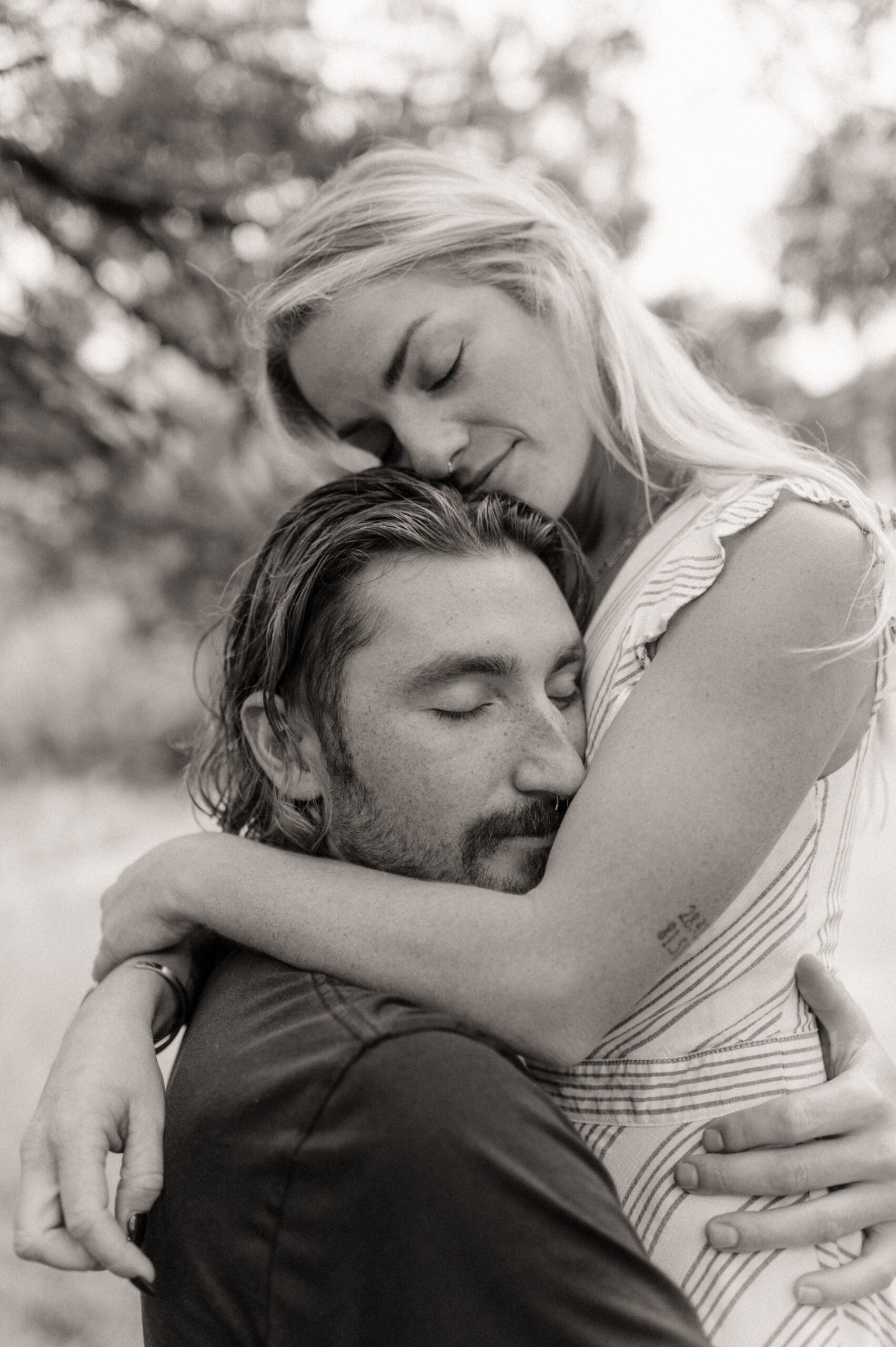 Intimate black and white engagement photo of a couple embracing closely during a St. Augustine engagement session. 