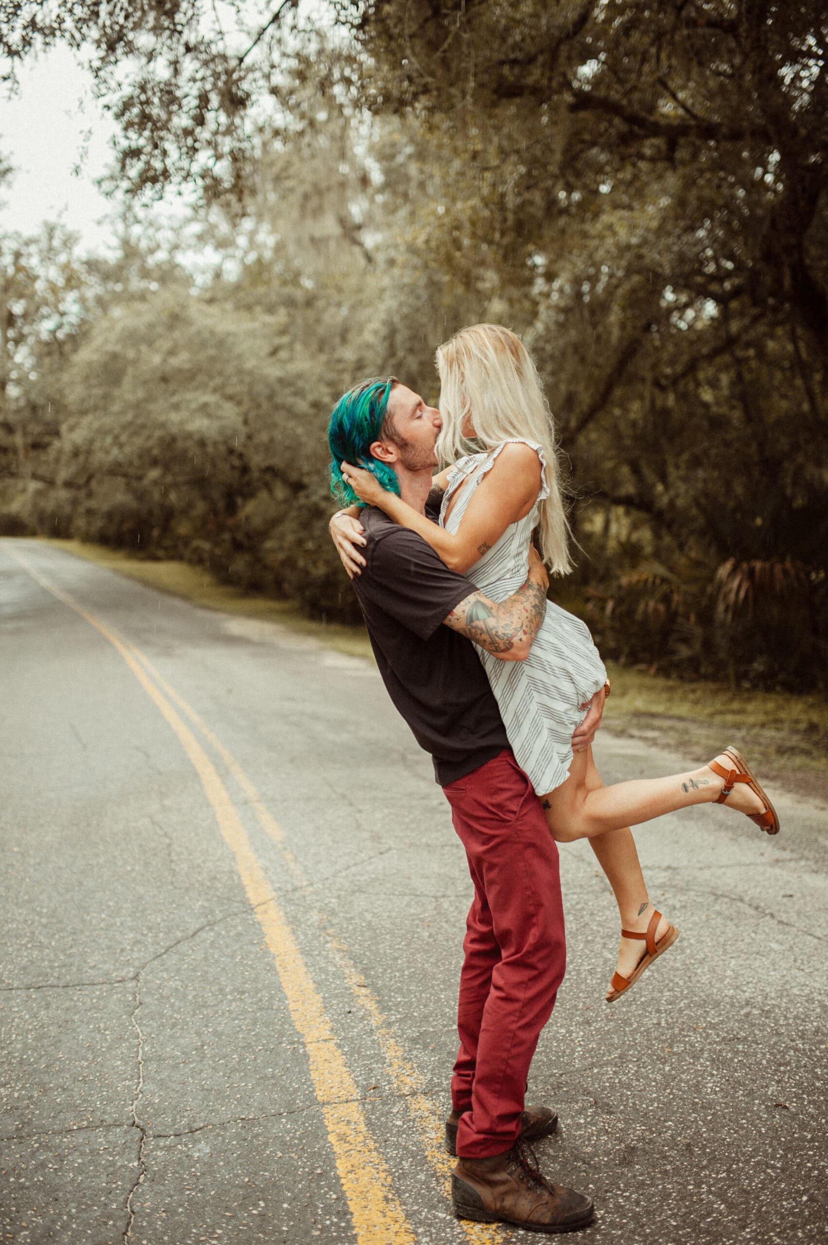Creative and playful engagement session with couple under oak trees in St. Augustine, Florida.