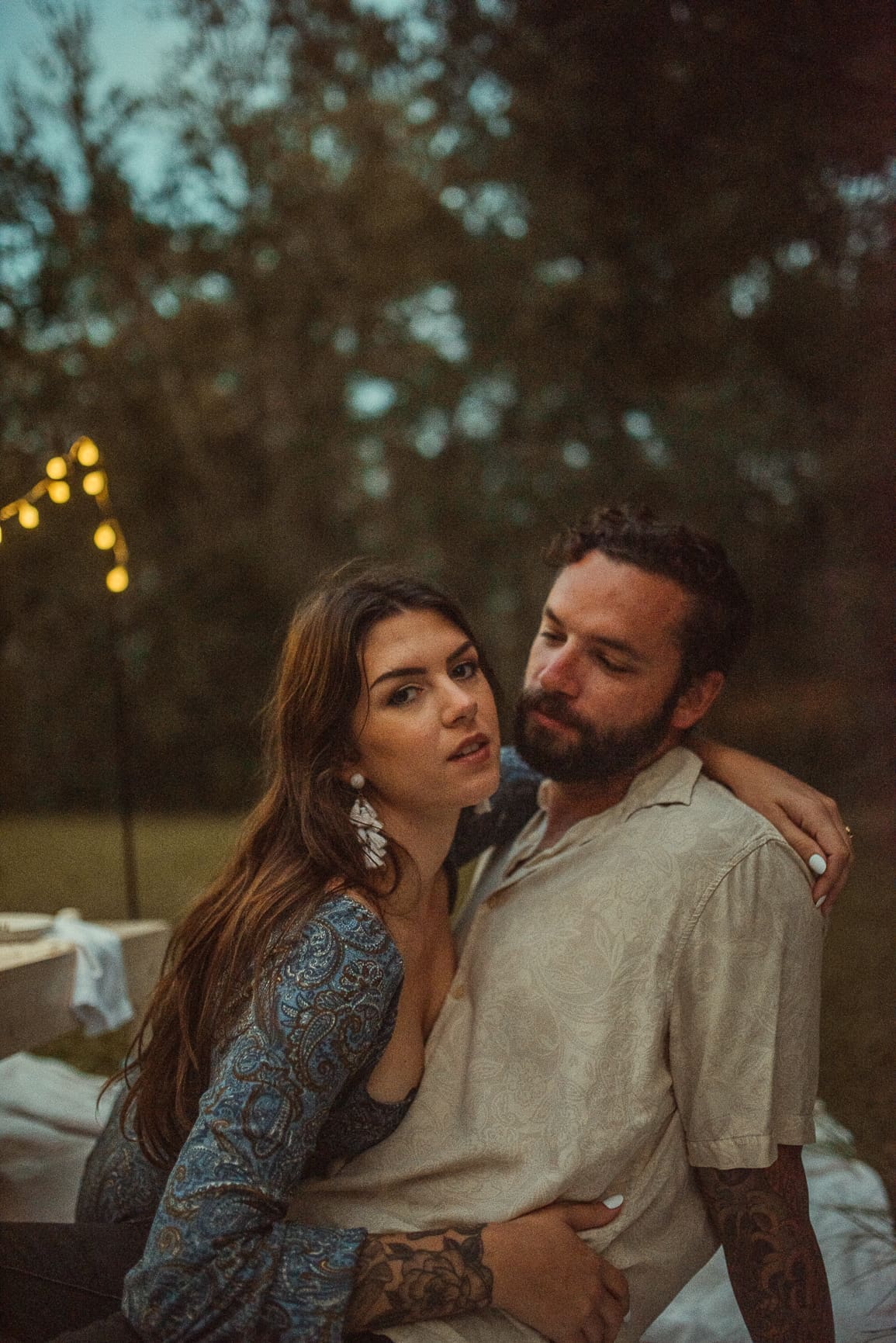 Couple sharing a romantic moment during an evening outdoor engagement session photographed by a St. Augustine wedding photographer. 
