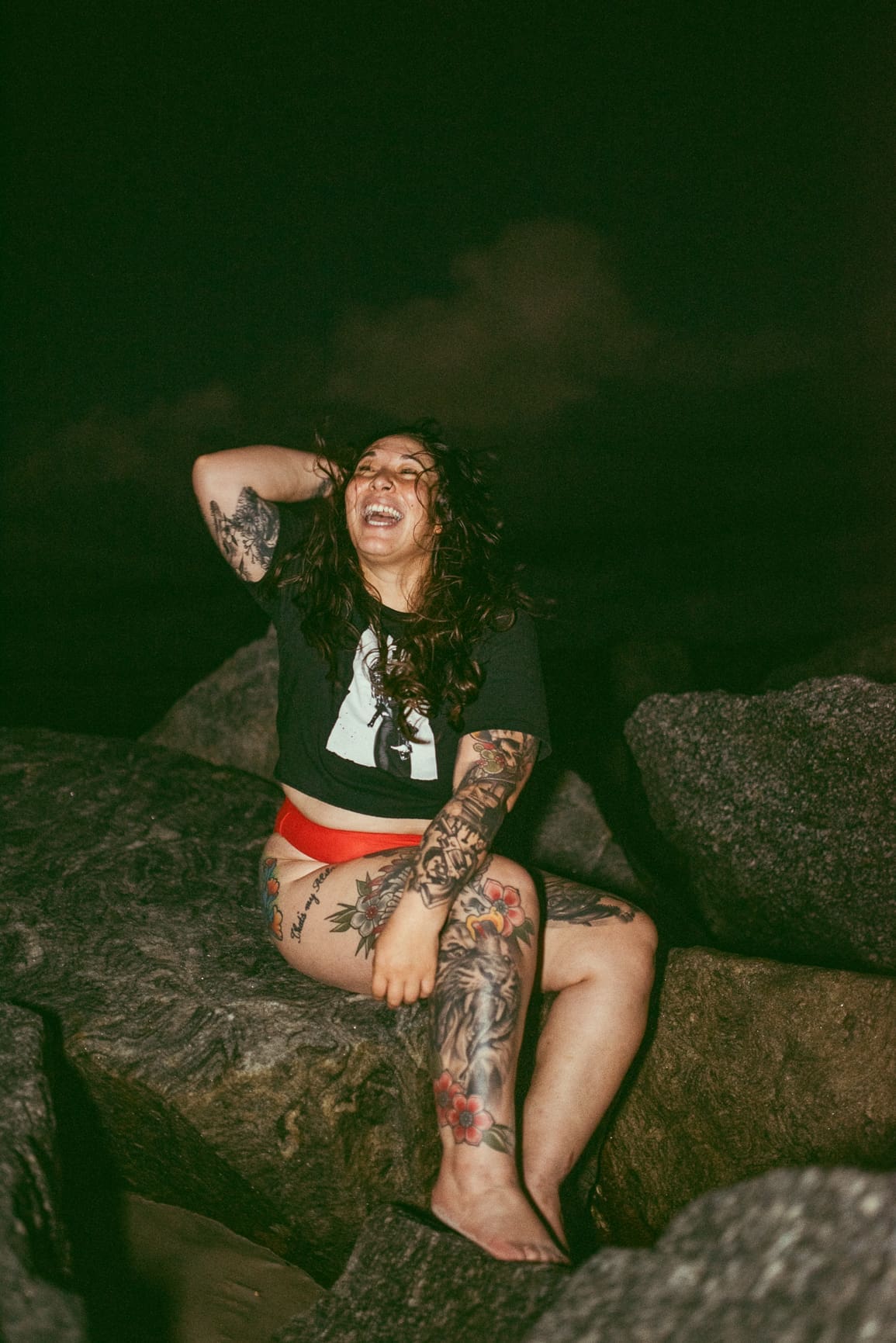 Woman laughing and feeling empowered during an artistic outdoor boudoir photography session in St. Augustine.