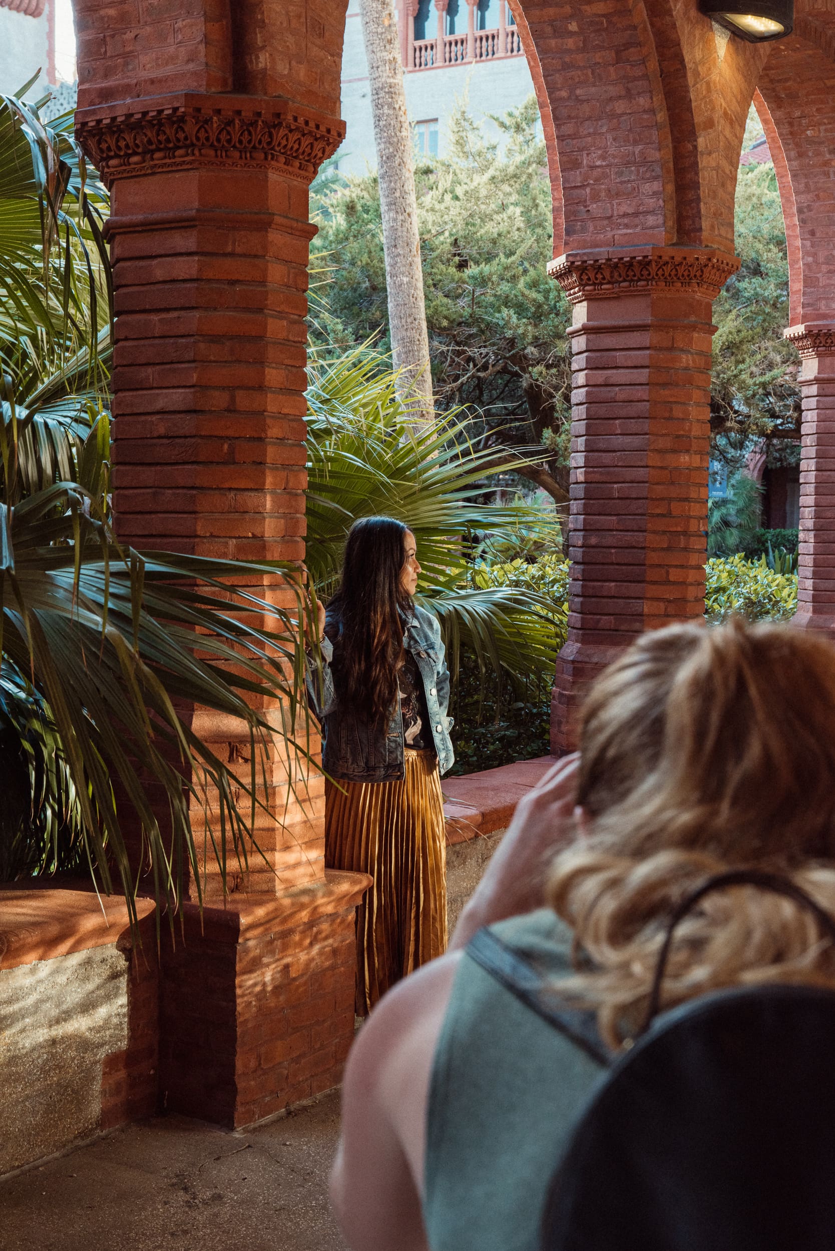 Hobbyist photographer capturing golden hour light beneath the arches of Flagler College