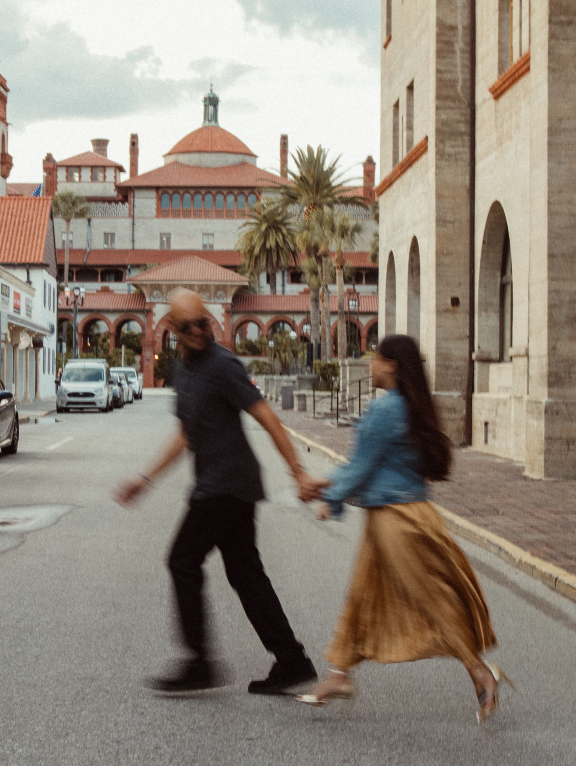 Motion blur photo of a couple walking hand in hand through downtown St. Augustine
