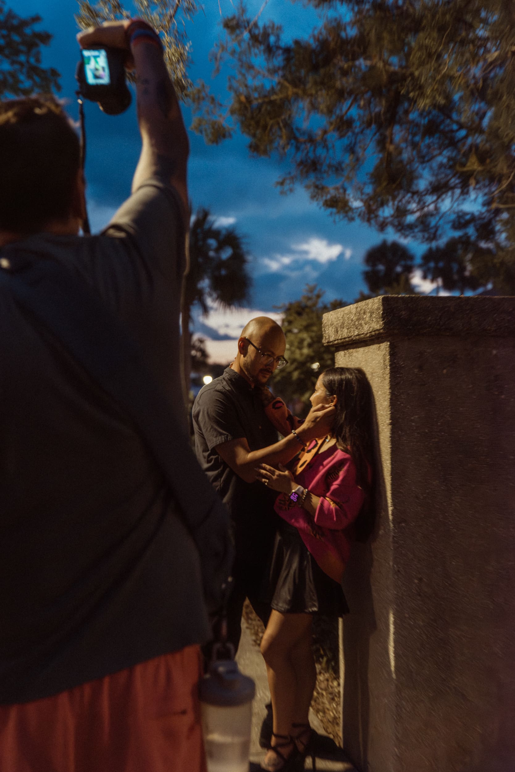 Photographer directing a couple during a golden hour portrait session in St. Augustine