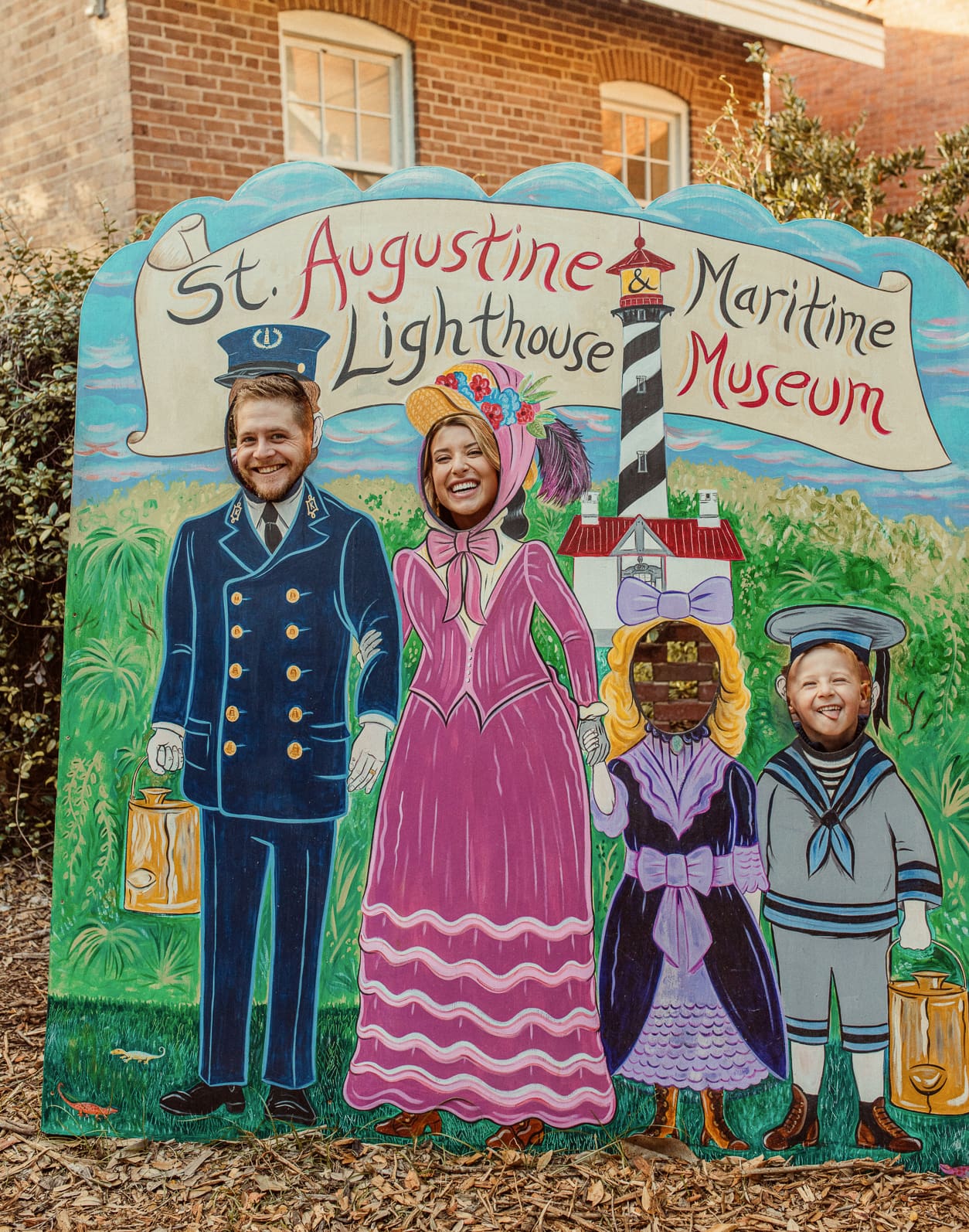 amily posing in the painted photo cutout at the St. Augustine Lighthouse & Maritime Museum