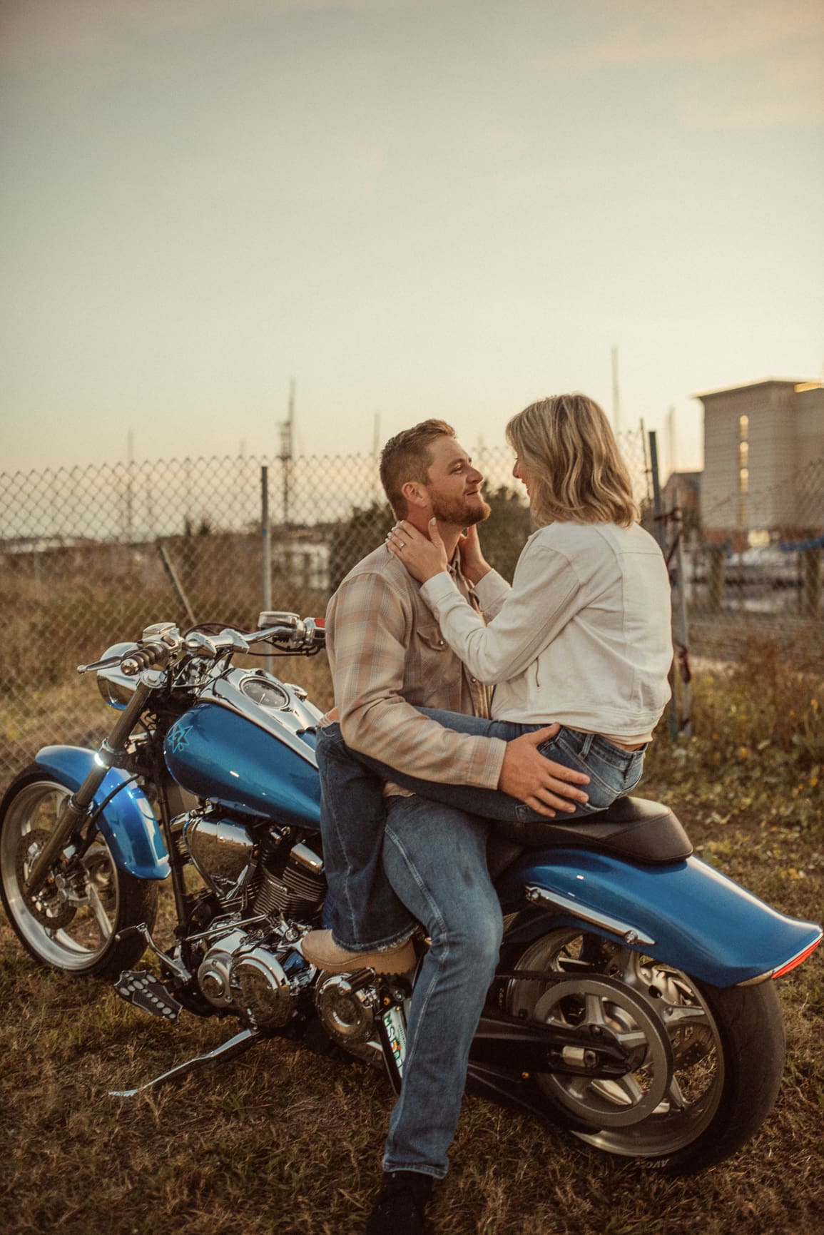 Engaged couple face to face on a blue motorcycle during their St. Augustine engagement session
