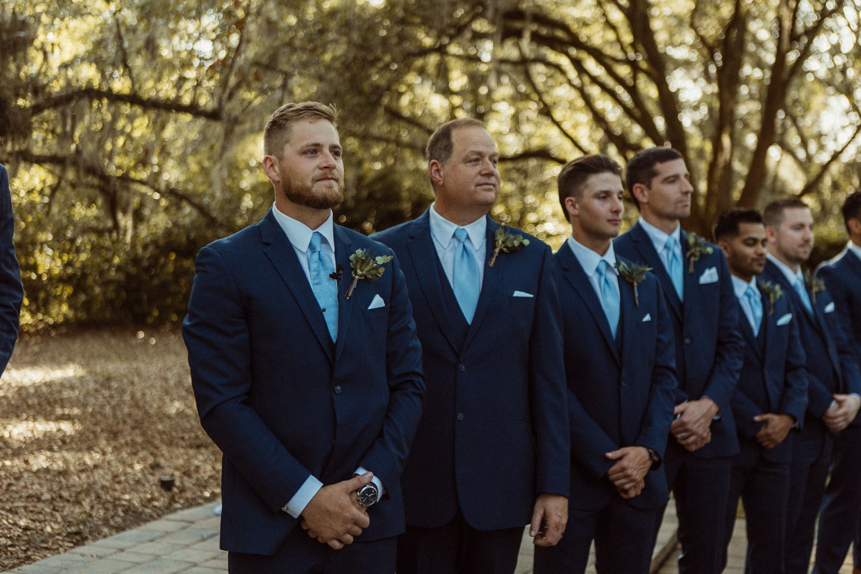 Groomsmen standing together during pre-ceremony portraits at Bowing Oaks. 