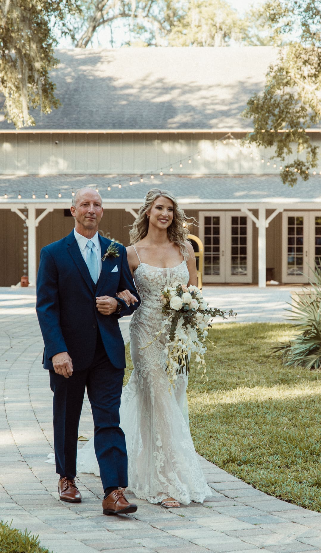 Bride walking wit her father before the ceremony at Bowing Oaks. 