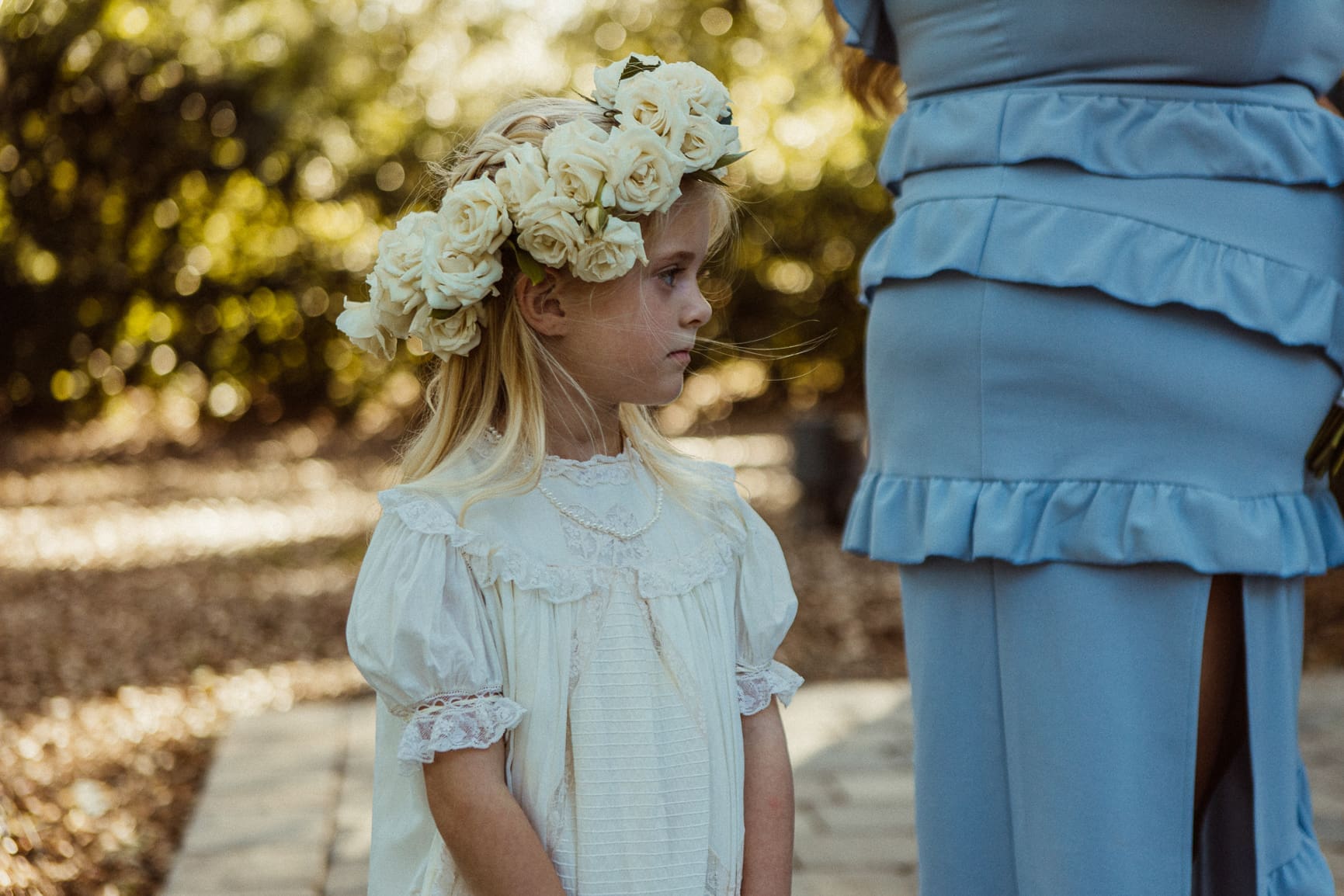 close-up of the flower girl wearing a crown of white roses. 