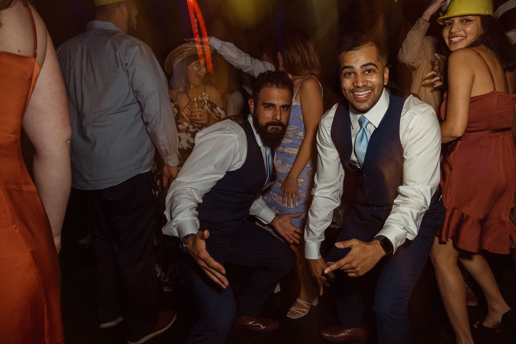 Groomsmen dancing and laughing on the dance floor at Bowing Oaks wedding reception. 