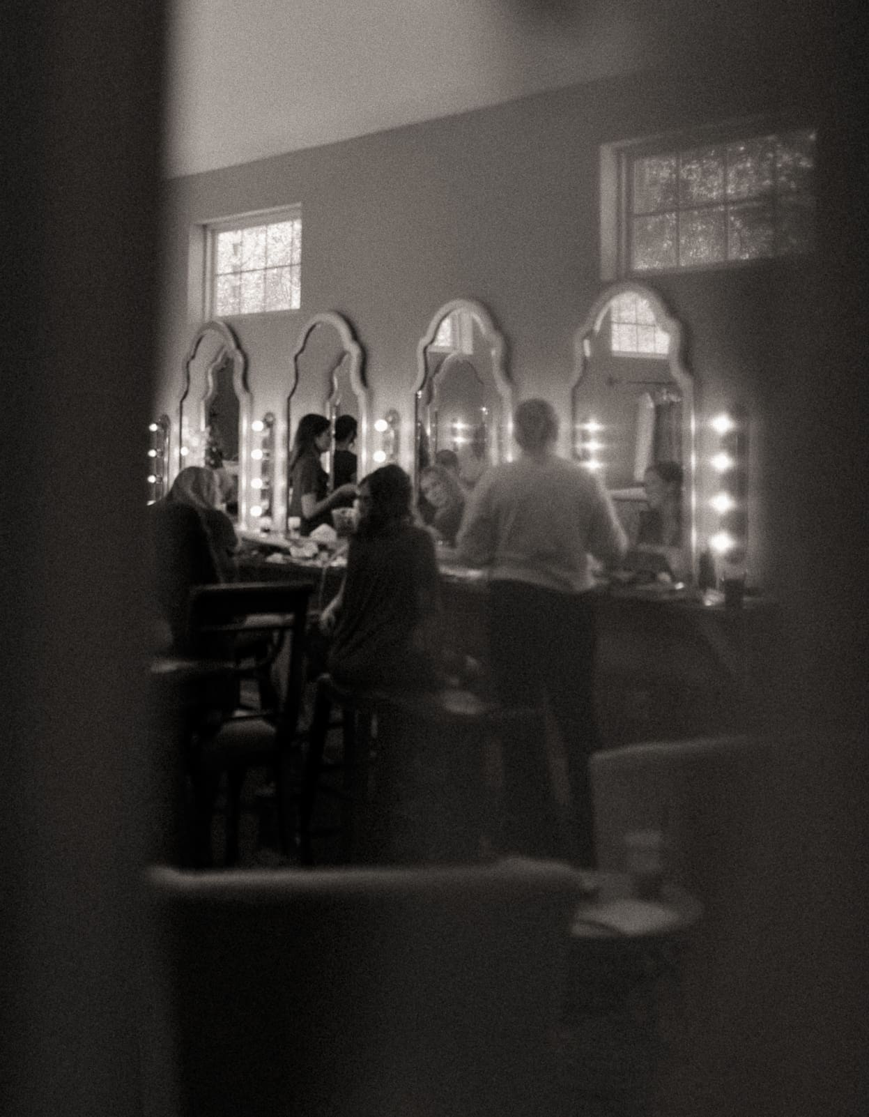Bridal party getting ready together, black and white wedding photo.