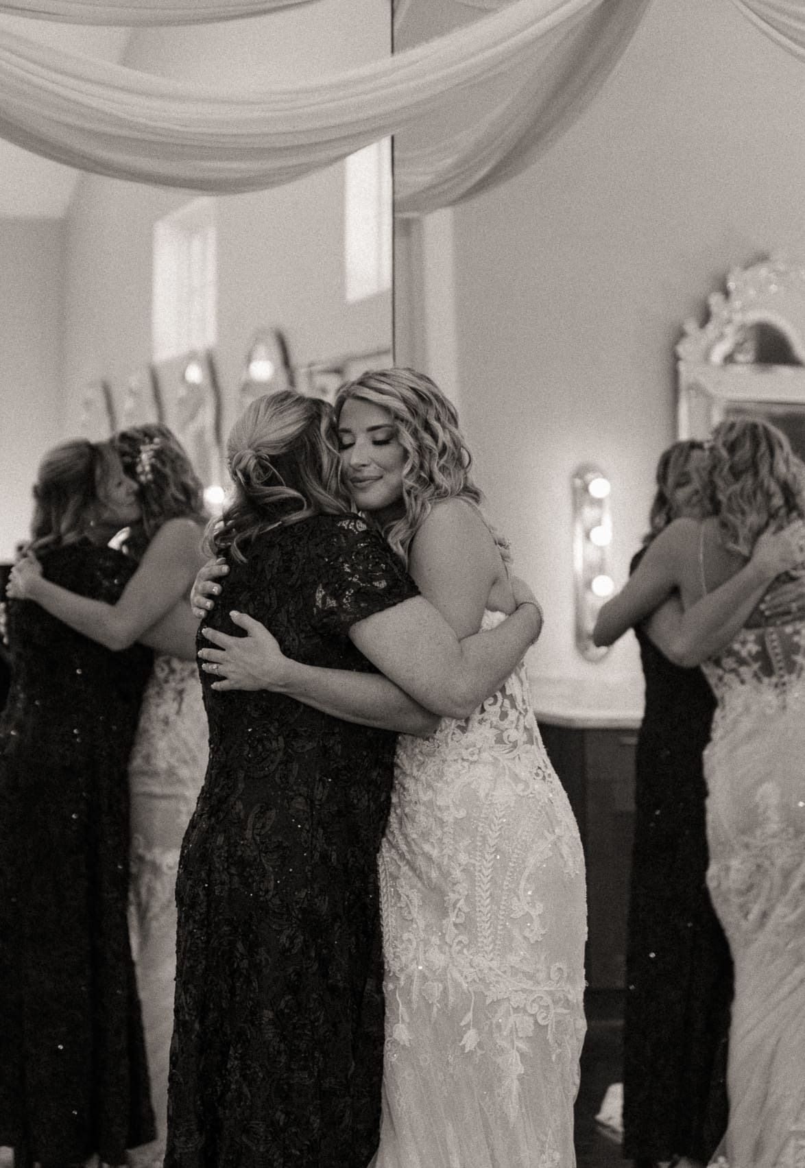 Bride hugging mother before the ceremony at Bowing Oaks. 