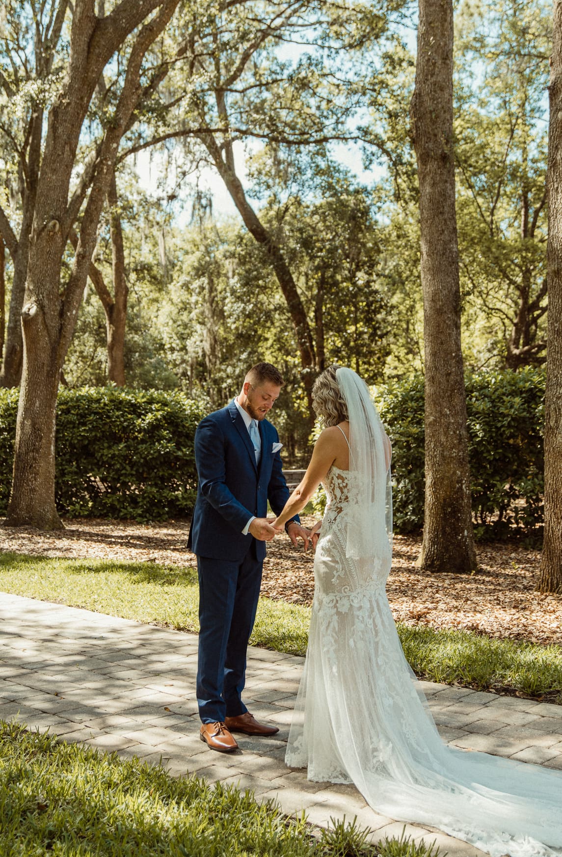 Bride and groom holding hands during a private vow reading at Bowing Oaks in Jacksonville.