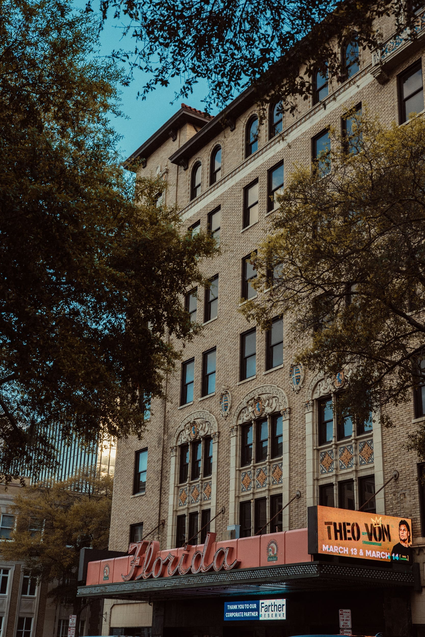 Historic Florida Theatre building and marquee framed by oak trees in downtown Jacksonville